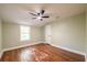 Bedroom featuring hardwood floors, green walls, ceiling fan and a window at 263 Ohm Ave, Avondale Estates, GA 30002
