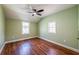 Bedroom with hardwood floors, green walls, ceiling fan and two windows at 263 Ohm Ave, Avondale Estates, GA 30002