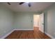 Bedroom featuring hardwood floors, green walls, white trim and a window at 263 Ohm Ave, Avondale Estates, GA 30002