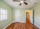 Bedroom featuring hardwood floors, green walls, white trim and a window at 263 Ohm Ave, Avondale Estates, GA 30002