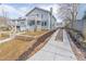 A charming two-story home features a stone wall, long driveway and a small second story balcony at 263 Ohm Ave, Avondale Estates, GA 30002