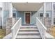 Inviting front entrance featuring stone steps, white railings, and a covered porch at 263 Ohm Ave, Avondale Estates, GA 30002