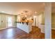 Open kitchen boasts recessed lighting, granite countertops, island with pendant lights, and stainless appliances at 263 Ohm Ave, Avondale Estates, GA 30002