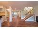 Open living room with staircase, kitchen, and hardwood floors at 263 Ohm Ave, Avondale Estates, GA 30002