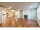 Bright living room featuring hardwood floors, a fireplace, and an open layout leading to the kitchen at 263 Ohm Ave, Avondale Estates, GA 30002