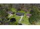 Aerial view of a gray house surrounded by trees and lush green lawn at 282 Oak Se Dr, Atlanta, GA 30354