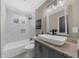 Modern bathroom with white tile surround tub, sleek vanity, and granite countertop at 282 Oak Se Dr, Atlanta, GA 30354