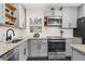 Modern kitchen featuring gray cabinets, herringbone backsplash, stainless steel appliances, and granite countertops at 282 Oak Se Dr, Atlanta, GA 30354