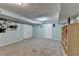 Finished basement with light-blue walls, neutral carpet, and a built-in storage unit at 639 Oak Moss Dr, Lawrenceville, GA 30043