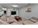 Spacious basement living area featuring a large sectional sofa and built-in entertainment center at 639 Oak Moss Dr, Lawrenceville, GA 30043