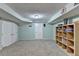Finished basement with light-blue walls, neutral carpet, and a built-in storage unit at 639 Oak Moss Dr, Lawrenceville, GA 30043