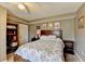 Bedroom with bookshelf, wooden headboard, and neutral carpet at 639 Oak Moss Dr, Lawrenceville, GA 30043