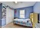 This cozy bedroom offers blue walls, a ceiling fan, and ample storage in the white closet at 639 Oak Moss Dr, Lawrenceville, GA 30043