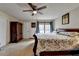 Bedroom with a large bed, carpeted floors, and ample storage in the wardrobe at 639 Oak Moss Dr, Lawrenceville, GA 30043