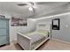 Cozy bedroom with brick accent wall, ceiling fan, and functional furniture at 639 Oak Moss Dr, Lawrenceville, GA 30043
