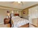 Comfortable bedroom with floral bedding, ceiling fan, and a neutral color scheme at 639 Oak Moss Dr, Lawrenceville, GA 30043