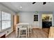 Bright dining area with a white table and chairs, offering a view of the laundry room at 639 Oak Moss Dr, Lawrenceville, GA 30043