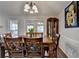 Inviting dining room featuring hardwood floors, a classic chandelier, and a decorative china cabinet at 639 Oak Moss Dr, Lawrenceville, GA 30043