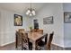 Cozy dining room showcasing a wooden table set, contemporary artwork, and neutral wall colors at 639 Oak Moss Dr, Lawrenceville, GA 30043