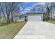 Inviting home with a large driveway leading to a two-car garage and a neatly kept front yard at 639 Oak Moss Dr, Lawrenceville, GA 30043