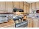 Close-up of the kitchen highlighting the countertops, oven, and wooden cabinetry at 639 Oak Moss Dr, Lawrenceville, GA 30043