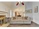 Bright living room featuring a stone fireplace and neutral-toned sectional sofa at 639 Oak Moss Dr, Lawrenceville, GA 30043