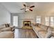 Inviting living room featuring a stone fireplace and neutral-toned sectional sofa at 639 Oak Moss Dr, Lawrenceville, GA 30043