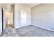 Spacious bedroom showcasing soft gray walls, carpeted floors, and an open doorway to another room at 266 Eva Ne Way, Cartersville, GA 30121