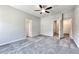 Spacious bedroom features gray carpet, ceiling fan, neutral paint, and doors to adjacent rooms at 266 Eva Ne Way, Cartersville, GA 30121