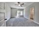 Bedroom with neutral walls, carpet, a ceiling fan, and natural light from the window at 266 Eva Ne Way, Cartersville, GA 30121