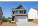 Charming two-story home with a stone-accented facade, two-car garage, and manicured lawn, perfect for curb appeal at 266 Eva Ne Way, Cartersville, GA 30121