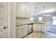 Bright kitchen features white cabinets, granite countertops, stainless steel appliances, and a stylish lighting fixture at 266 Eva Ne Way, Cartersville, GA 30121