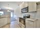 Contemporary kitchen with stainless steel appliances, granite countertops, and an open view into the living area at 266 Eva Ne Way, Cartersville, GA 30121