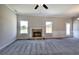 Inviting living room showcasing a cozy stone fireplace, large windows, and freshly painted walls, creating a warm atmosphere at 266 Eva Ne Way, Cartersville, GA 30121