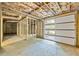 Unfinished basement with exposed framing, utilities, concrete floor and garage door at 276 Hermer Nw Cir, Atlanta, GA 30311