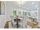 Elegant dining room with a wooden table, upholstered chairs, and natural light streaming through the window at 276 Hermer Nw Cir, Atlanta, GA 30311