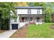 Charming two-story home with a covered front porch, black garage door, and beautifully landscaped yard at 276 Hermer Nw Cir, Atlanta, GA 30311