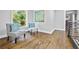 Hallway with hardwood floors, natural light, and modern decor creating an inviting transition space at 276 Hermer Nw Cir, Atlanta, GA 30311