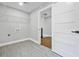 A modern laundry room with tiled floors, wire shelving, and a large opening to a second room at 276 Hermer Nw Cir, Atlanta, GA 30311
