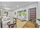 Bright living room featuring hardwood floors, large windows, and stylish decor for a cozy, inviting atmosphere at 276 Hermer Nw Cir, Atlanta, GA 30311