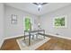 Bright home office featuring a sleek glass desk, hardwood floors, and natural light perfect for productivity at 276 Hermer Nw Cir, Atlanta, GA 30311
