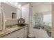 Bright bathroom featuring granite countertops, white cabinets and a shower with glass doors at 3452 Village Park Sw Ln, Atlanta, GA 30331
