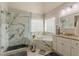 A lavish bathroom showcasing a soaking tub, granite counters, and a glass-enclosed shower at 3452 Village Park Sw Ln, Atlanta, GA 30331