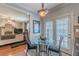 Cozy dining area features a glass table with seating for two, adjacent to the open-concept living area at 3452 Village Park Sw Ln, Atlanta, GA 30331