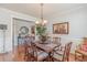 Traditional dining room with wood floors, neutral walls, wainscoting, and statement chandelier at 3452 Village Park Sw Ln, Atlanta, GA 30331