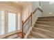 Light-filled entryway with wood staircase, and tile floor at 3452 Village Park Sw Ln, Atlanta, GA 30331