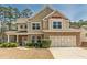 Charming two-story home with stone accents, attached garage, and well-manicured landscaping at 3452 Village Park Sw Ln, Atlanta, GA 30331