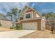 Attractive two-story home with stone accents and an attached garage in a Gathering-friendly neighborhood at 3452 Village Park Sw Ln, Atlanta, GA 30331