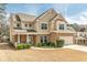 Attractive two-story home with stone accents, well-manicured lawn, and a cozy front porch at 3452 Village Park Sw Ln, Atlanta, GA 30331