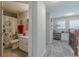 Hallway leading to a full bathroom featuring a tiled shower and white vanity at 3452 Village Park Sw Ln, Atlanta, GA 30331